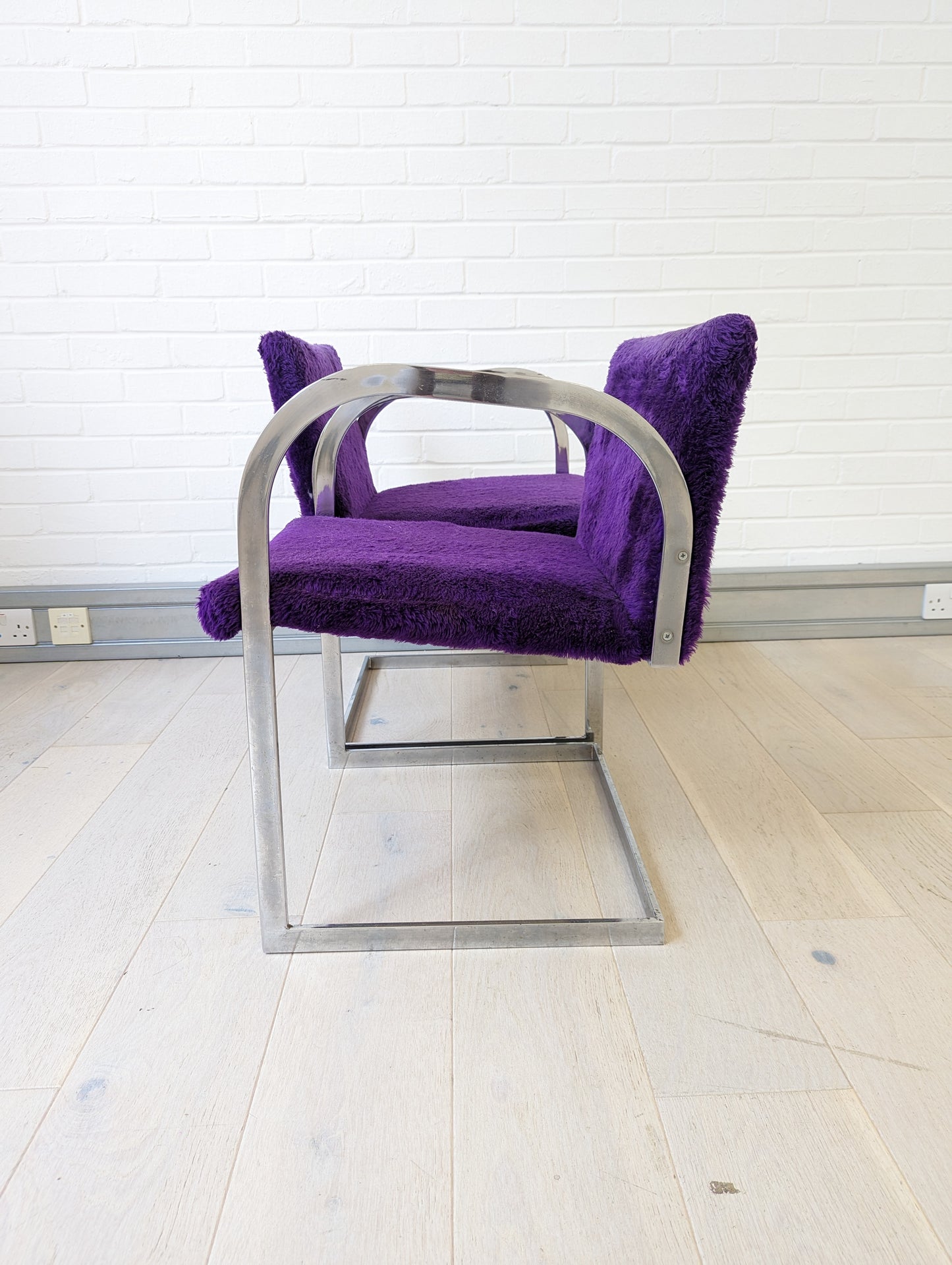 A pair of 1960's faux purple shag chairs after Mies van der Rohe